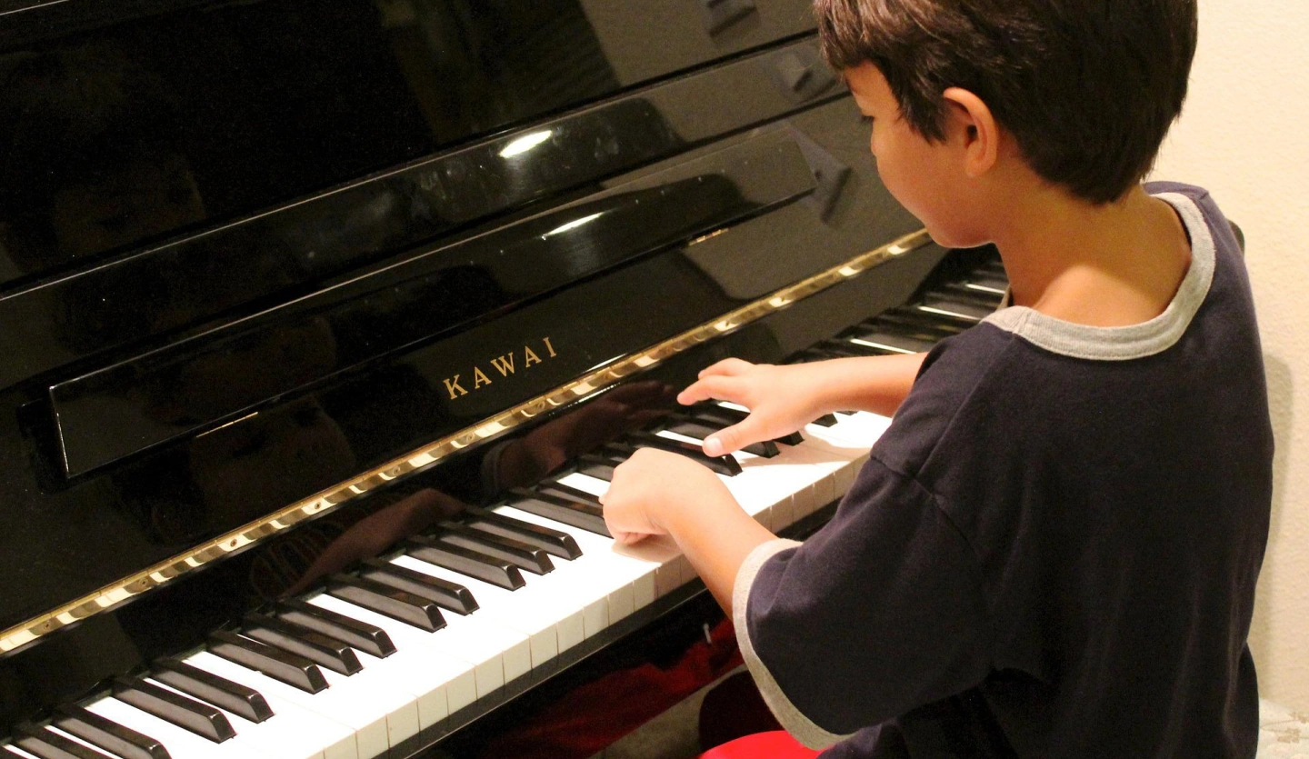 Music students taking piano lessons